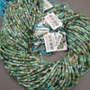 Close-up of African turquoise jasper beads displaying natural-looking mottled patterns and varied green tones.