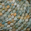 Close-up of faceted amazonite oval beads with aqua, cream and peach patches