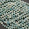 Multiple strands of polished amazonite round beads displaying pastel shades of turquoise, mint green, and ivory.