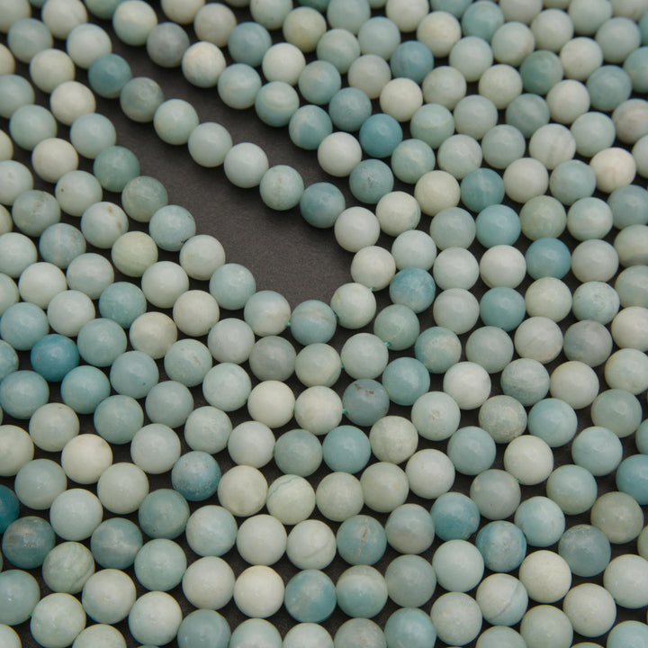 Pale blue amazonite gemstone beads with a smooth finish and gentle color variations for handmade bracelets and necklaces.