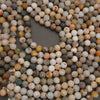 Natural Bamboo Leaf Agate round beads with varied organic patterns