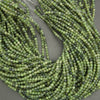 Green jade round beads close up showing natural variation and inclusions