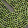 Round light green jade beads.