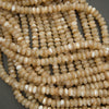Close-up of a string of beige beads on a gray background