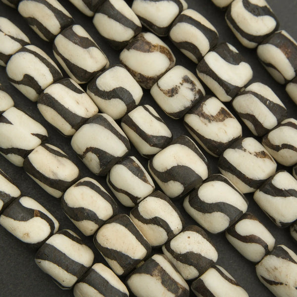 Close-up of black and white patterned beads on a dark background