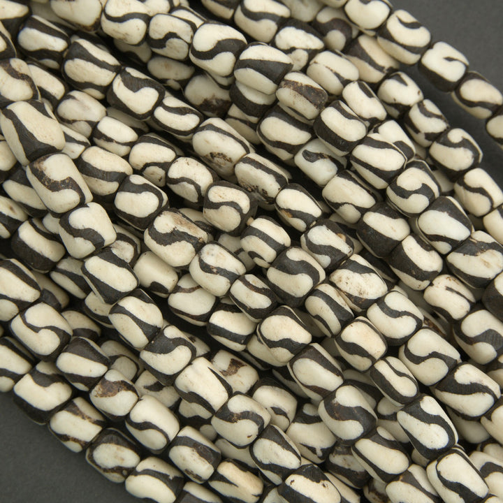 Close-up of black and white patterned beads on a dark background