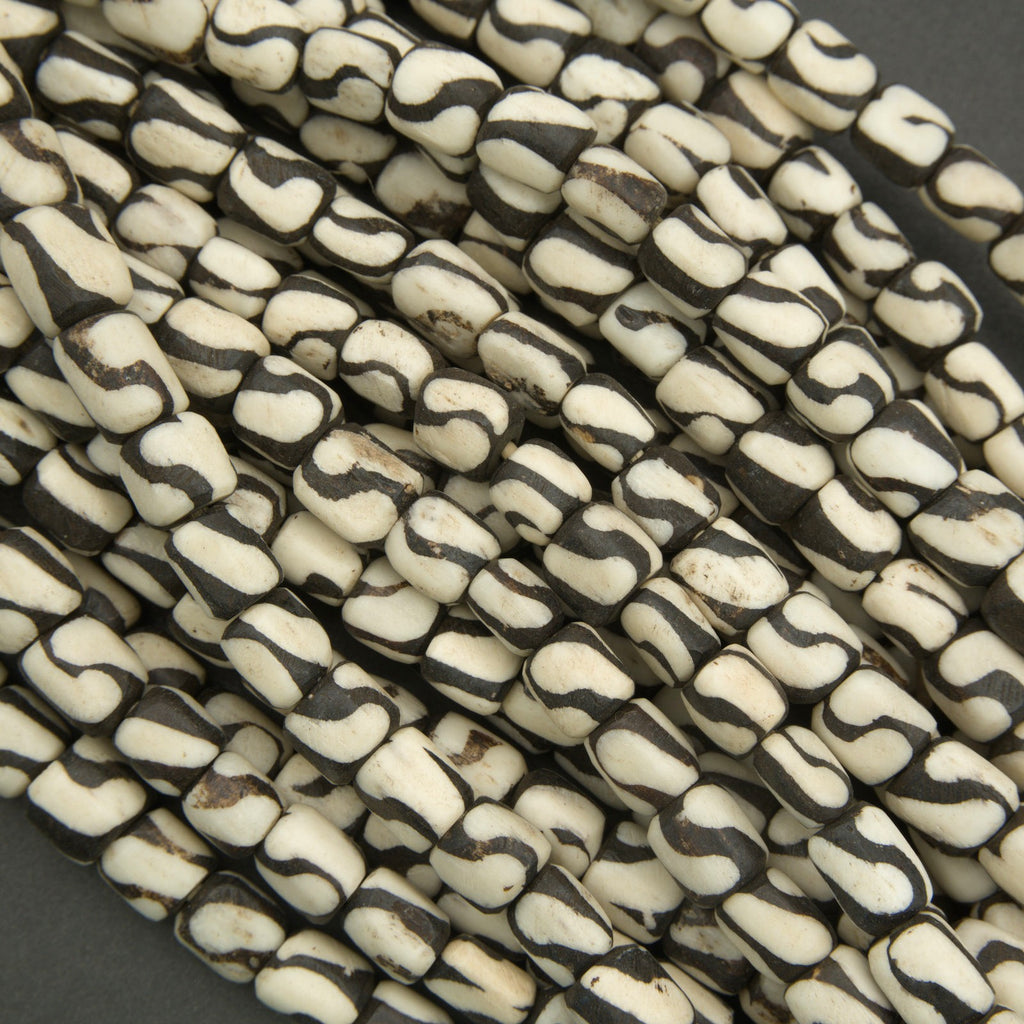 Close-up of black and white patterned beads on a dark background