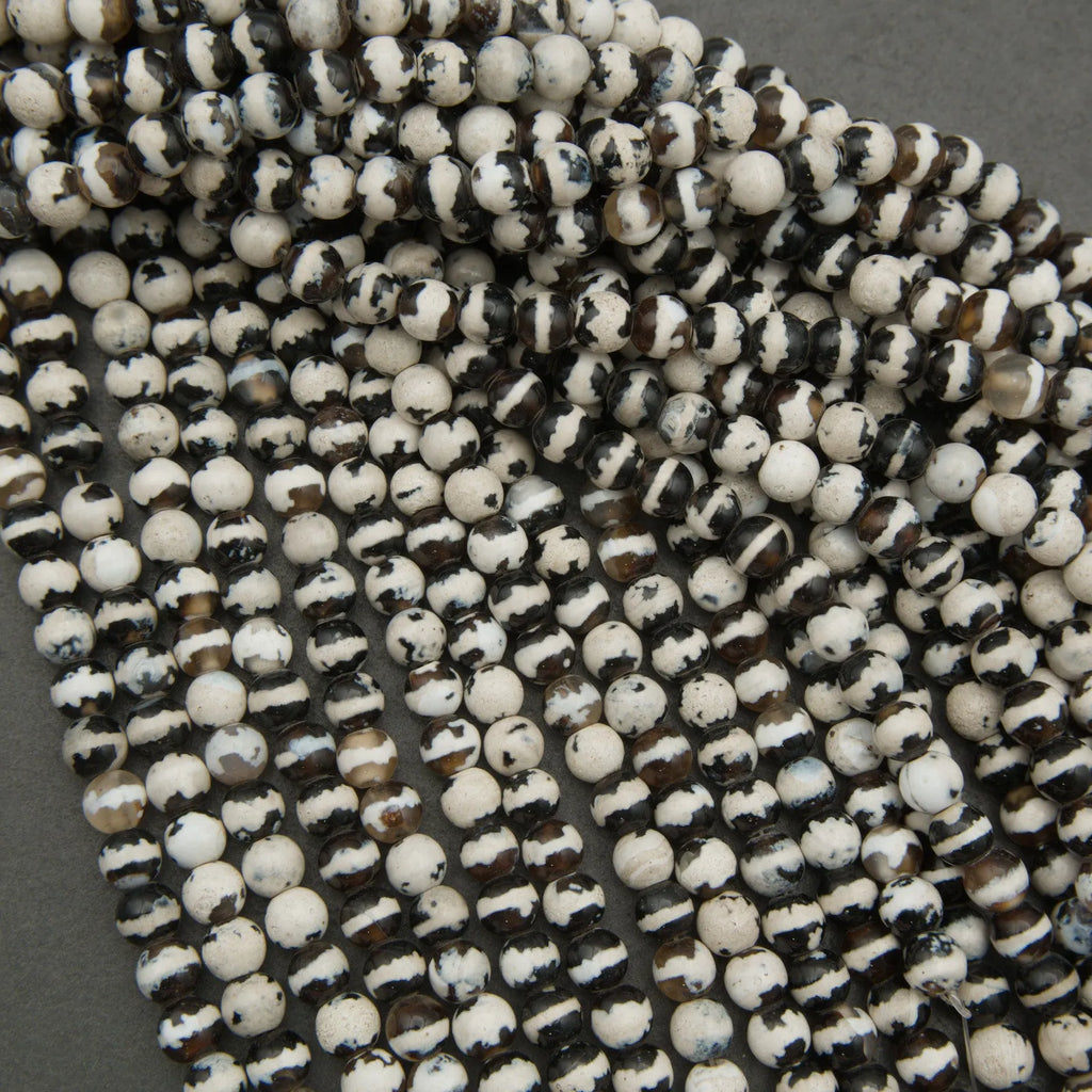 Close-up of black and white beads on a gray background