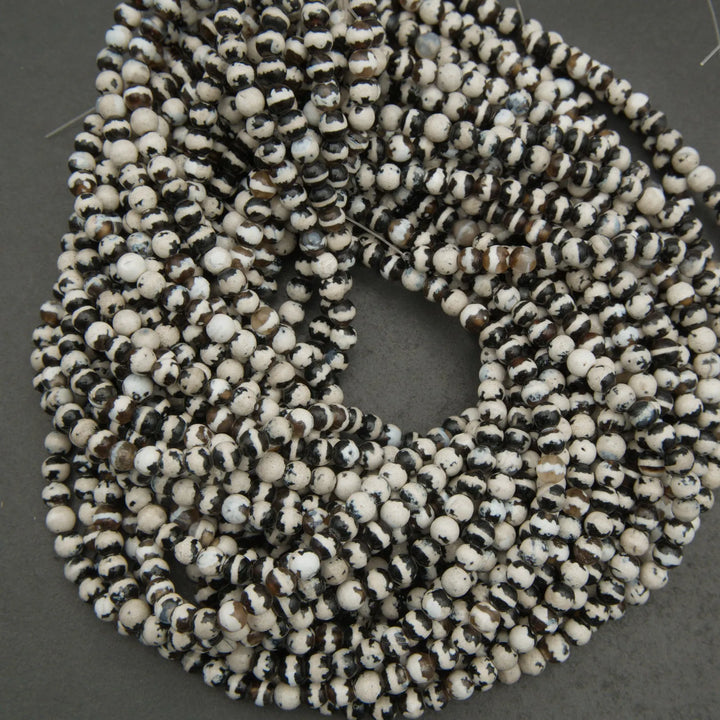 String of black and white beads on a gray background