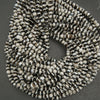 String of black and white beads on a gray background