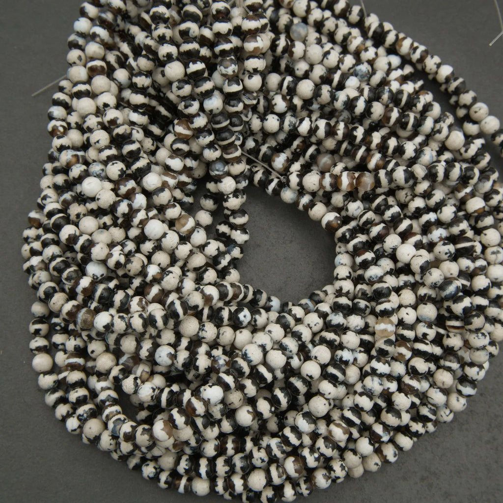 String of black and white beads on a gray background