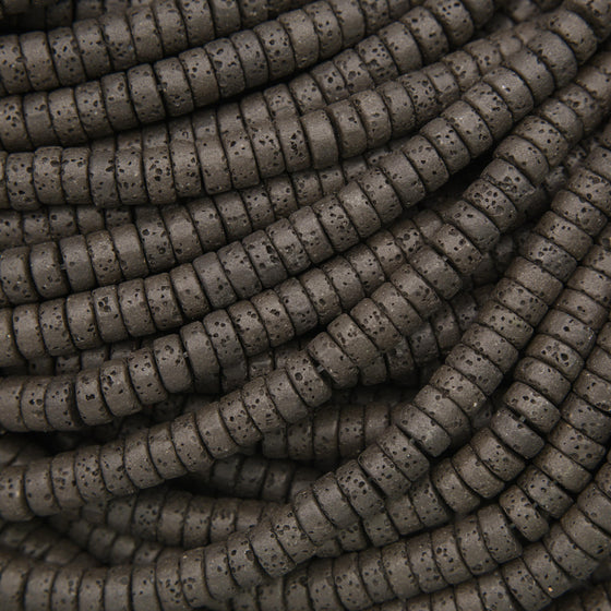Black lava stone heishi beads with a matte finish and naturally porous volcanic texture for jewelry making.