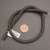 Black volcanic lava rock heishi spacer beads featuring rounded edges and naturally pitted matte surfaces.