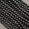 Polished Black Tourmaline gemstone beads with deep black color and earthy brown accents