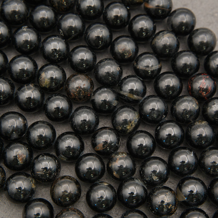 Polished round Black Tourmaline beads with black, brown, and gray natural patterning