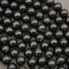 Polished round Black Tourmaline beads with black, brown, and gray natural patterning