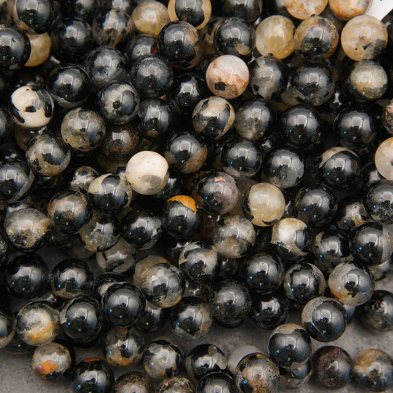 Black tourmaline gemstone beads with quartz, tan, and smoky gray markings