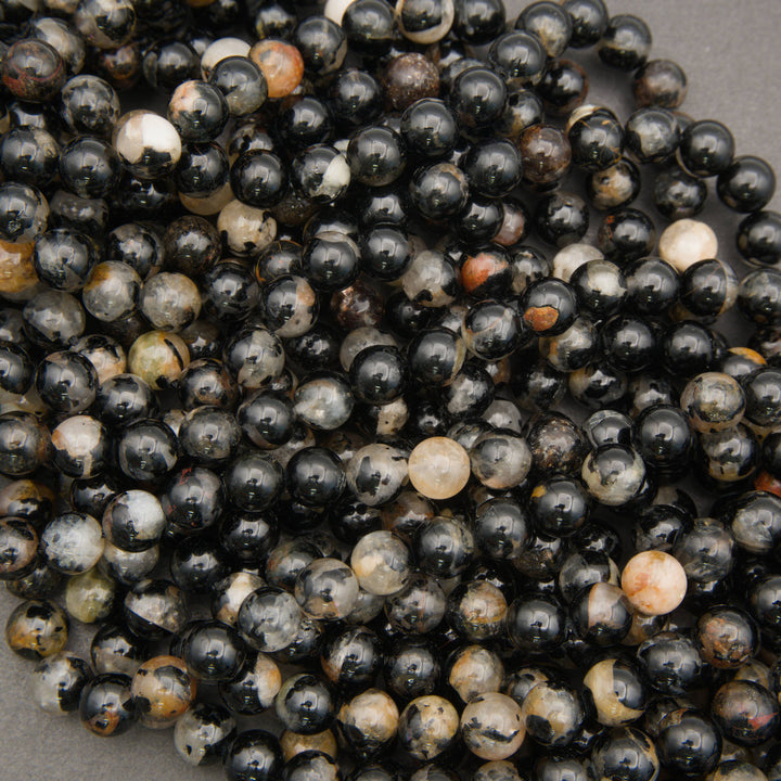 Black and cream Tourmaline in Quartz beads with varied natural patterns