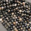Close-up of glossy Black Tourmaline in Quartz round beads