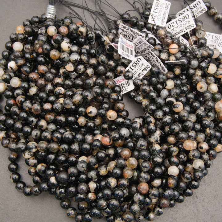 Black tourmaline gemstone beads with quartz, tan, and smoky gray markings