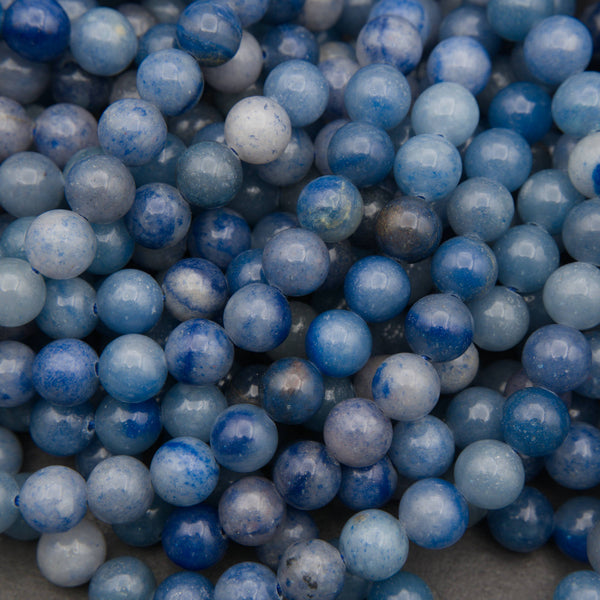 Close-up of smooth round blue aventurine beads in cobalt and denim blue with pale gray patches