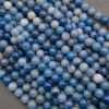 A heap of smooth round blue aventurine bead strands in denim blue, cobalt and soft gray