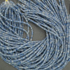 Blue aventurine rondelle beads close up showing natural variation