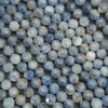 Close-up of blue faceted beads on a dark background