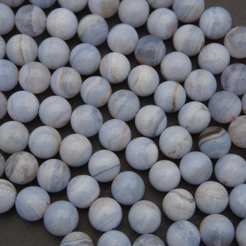 Close-up of blue and white marbled beads on a dark surface