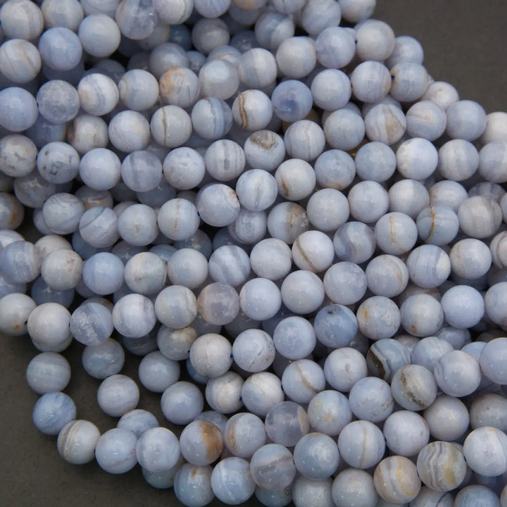 Close-up of blue and white marbled beads on a dark background