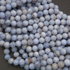 Close-up of blue and white marbled beads on a dark background