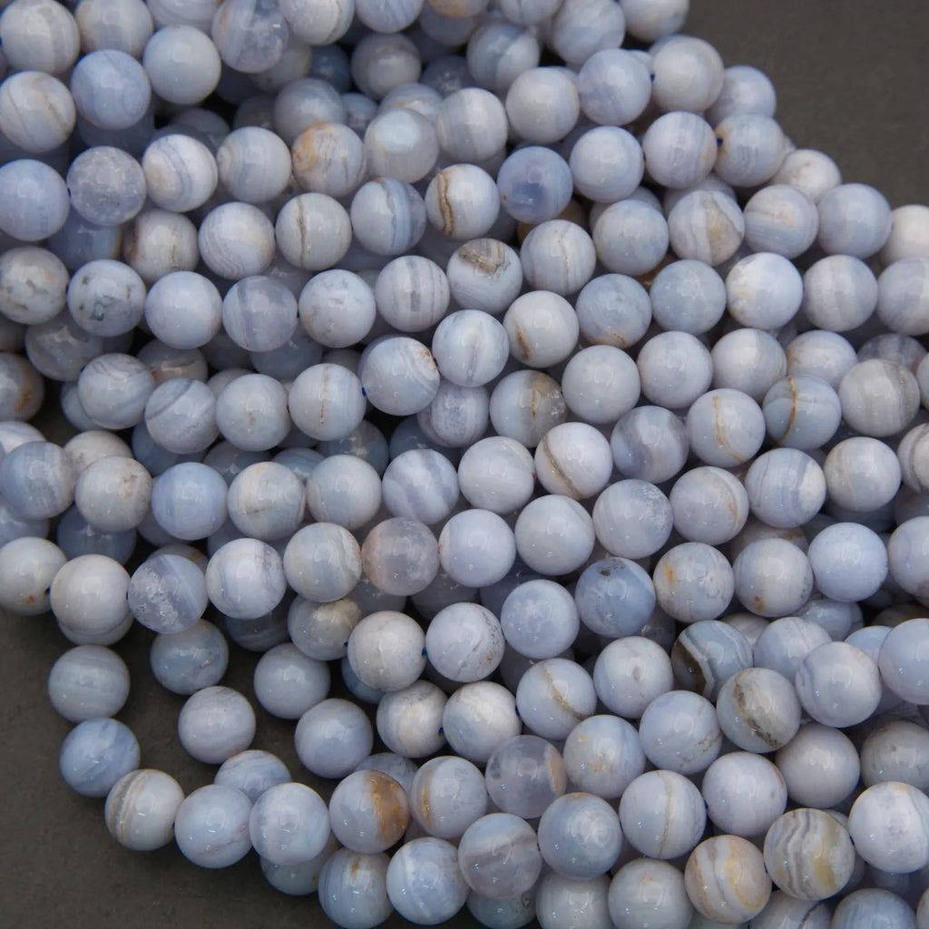 Close-up of blue and white marbled beads on a dark background