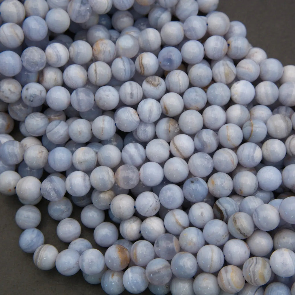 Close-up of blue and white marbled beads on a dark background