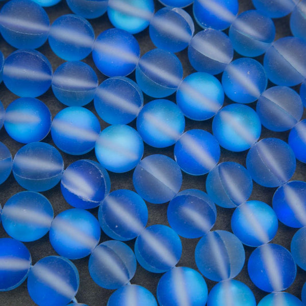 Close-up of blue glass beads on a dark background