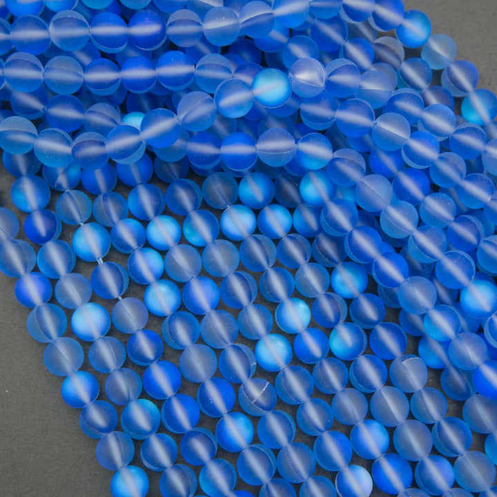 Close-up of blue glass beads on a dark background