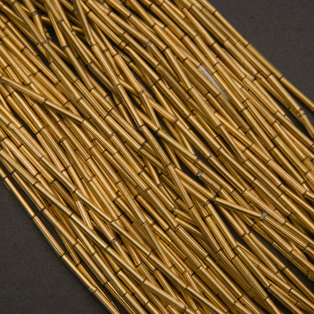 Handcrafted brass tube beads, elongated and slightly irregular with natural golden luster