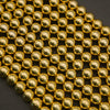 Close-up of gold beads arranged in a grid pattern on a dark background