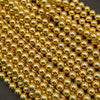 Close-up of gold beads on a dark background
