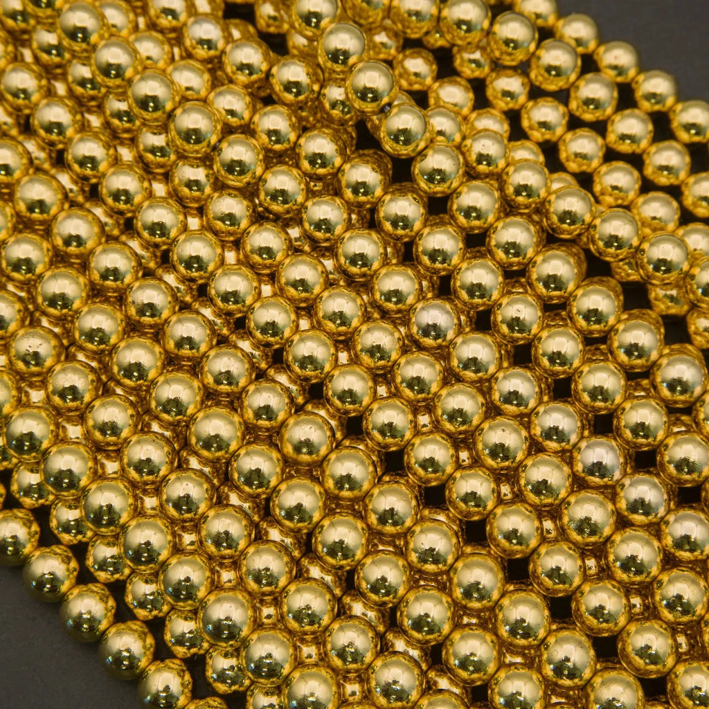Close-up of gold beads on a dark background