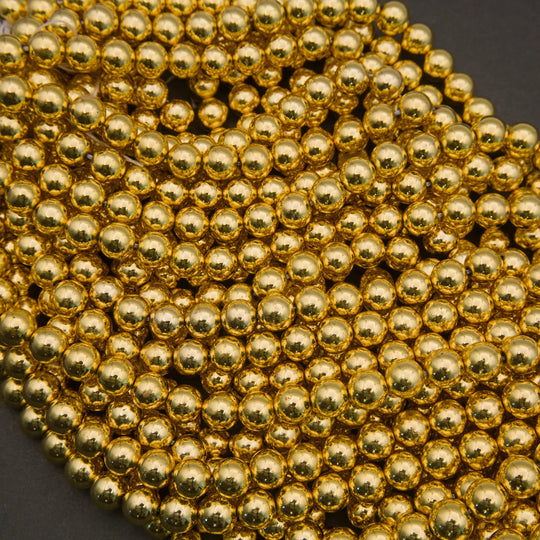 Close-up of a string of gold beads on a dark background
