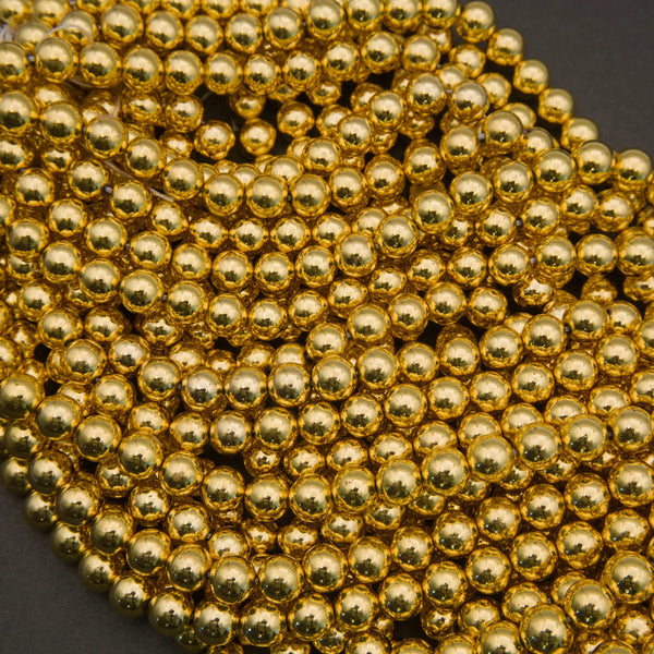 Close-up of a string of gold beads on a dark background