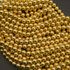Close-up of a string of gold beads on a dark background