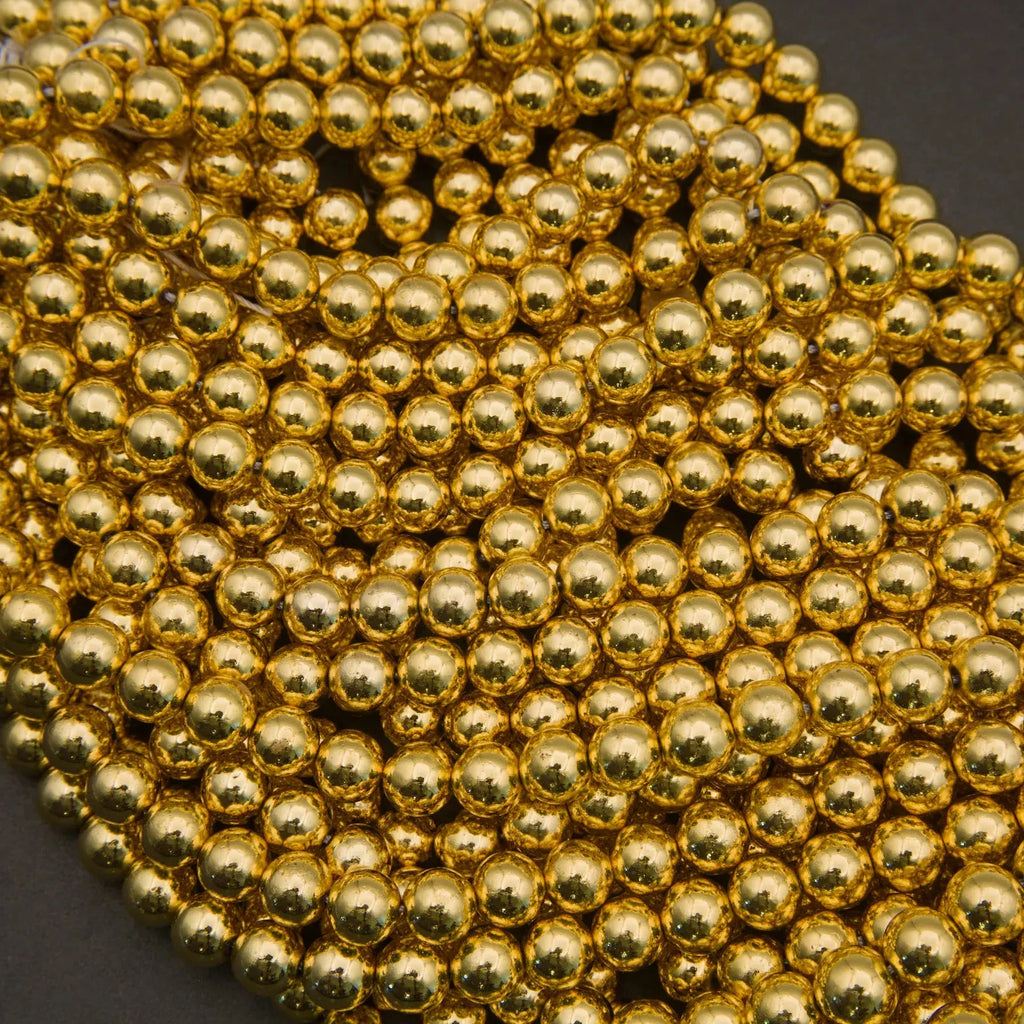 Close-up of a string of gold beads on a dark background