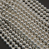 Close-up of silver beads arranged in a pattern