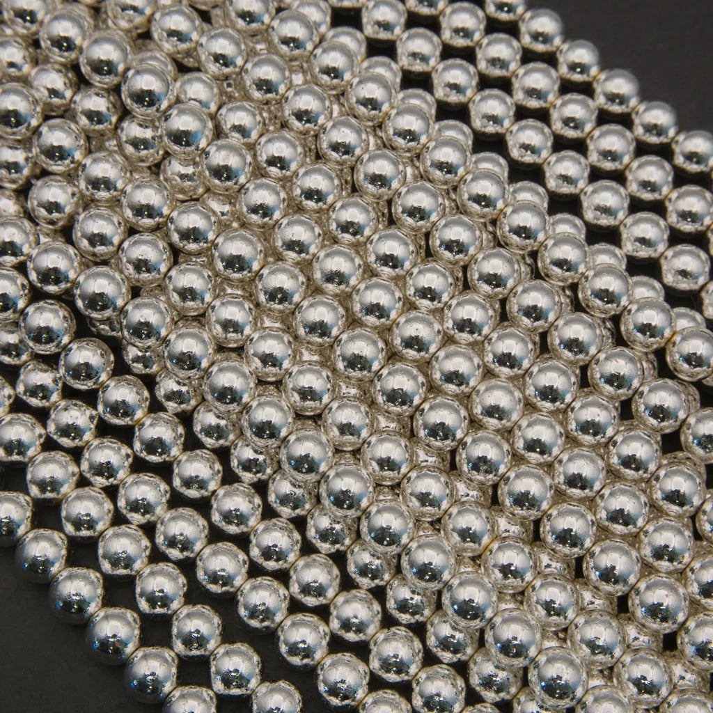 Close-up of silver beads arranged in a pattern