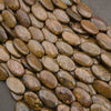 Close-up of strands of smooth oval bronzite beads in bronze, golden brown and chocolate with a fibrous metallic sheen