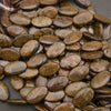 A heap of smooth oval bronzite bead strands with a bronze shimmer and patches of gray