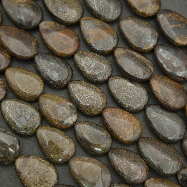 Close-up of smooth, polished stones on a dark surface