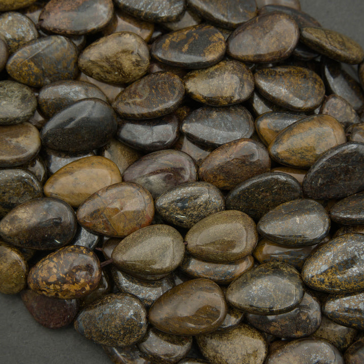 Close-up of dark brown pebbles on a gray background