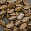 A pile of polished brown and gold jasper stone beads with natural striations, shown in a close-up view on a dark gray background.